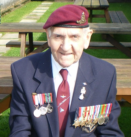 Eric Milner wearing a maroon beret and medals