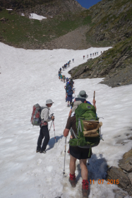 Walkers crossing a snow field on the Chemin de la Liberte